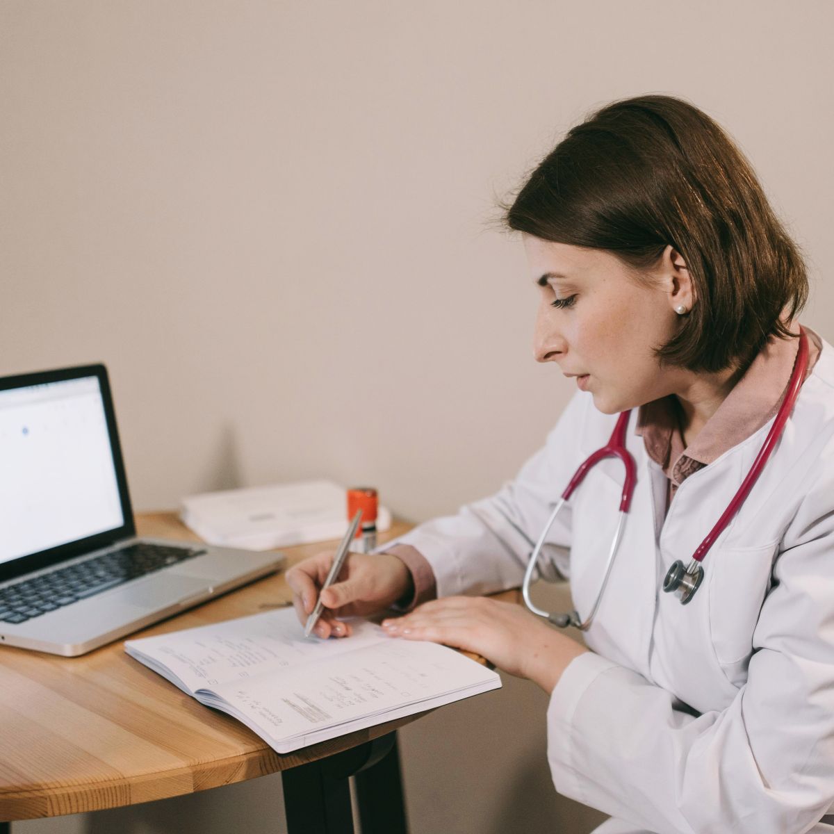 Female doctor writing in notebook.