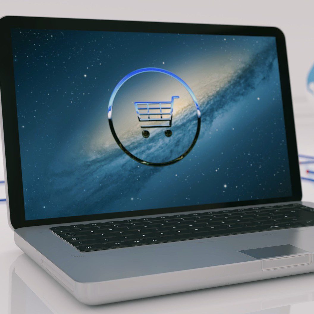 laptop computer with a shopping cart icon.