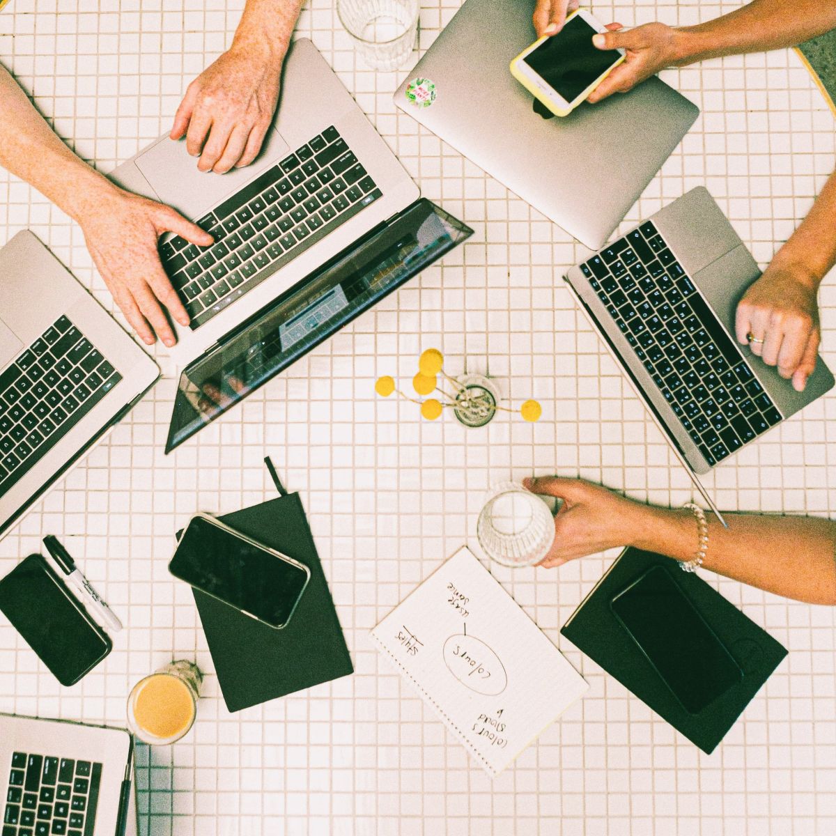 overhead image of table with computers and phones.