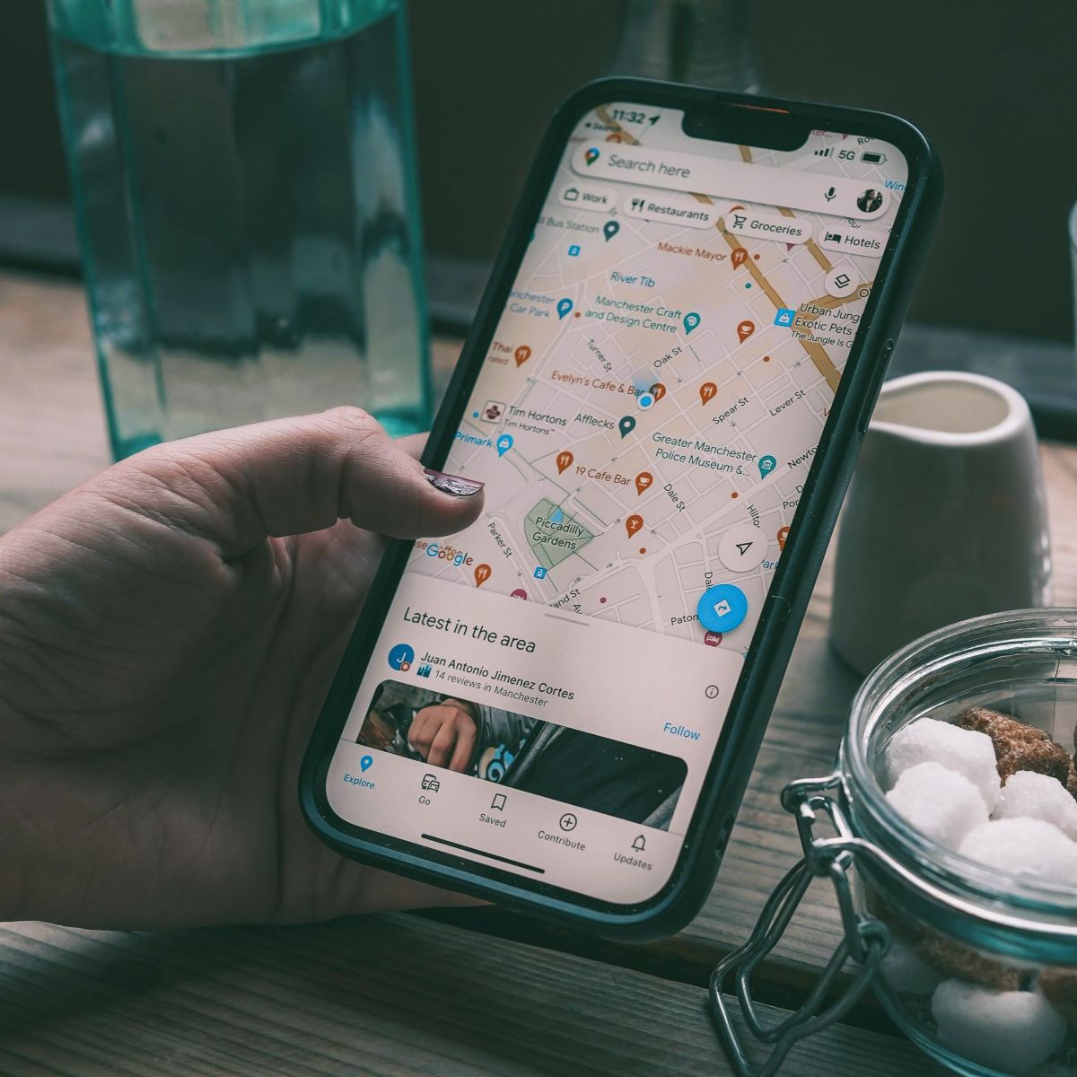 Hand holding phone showing a map.