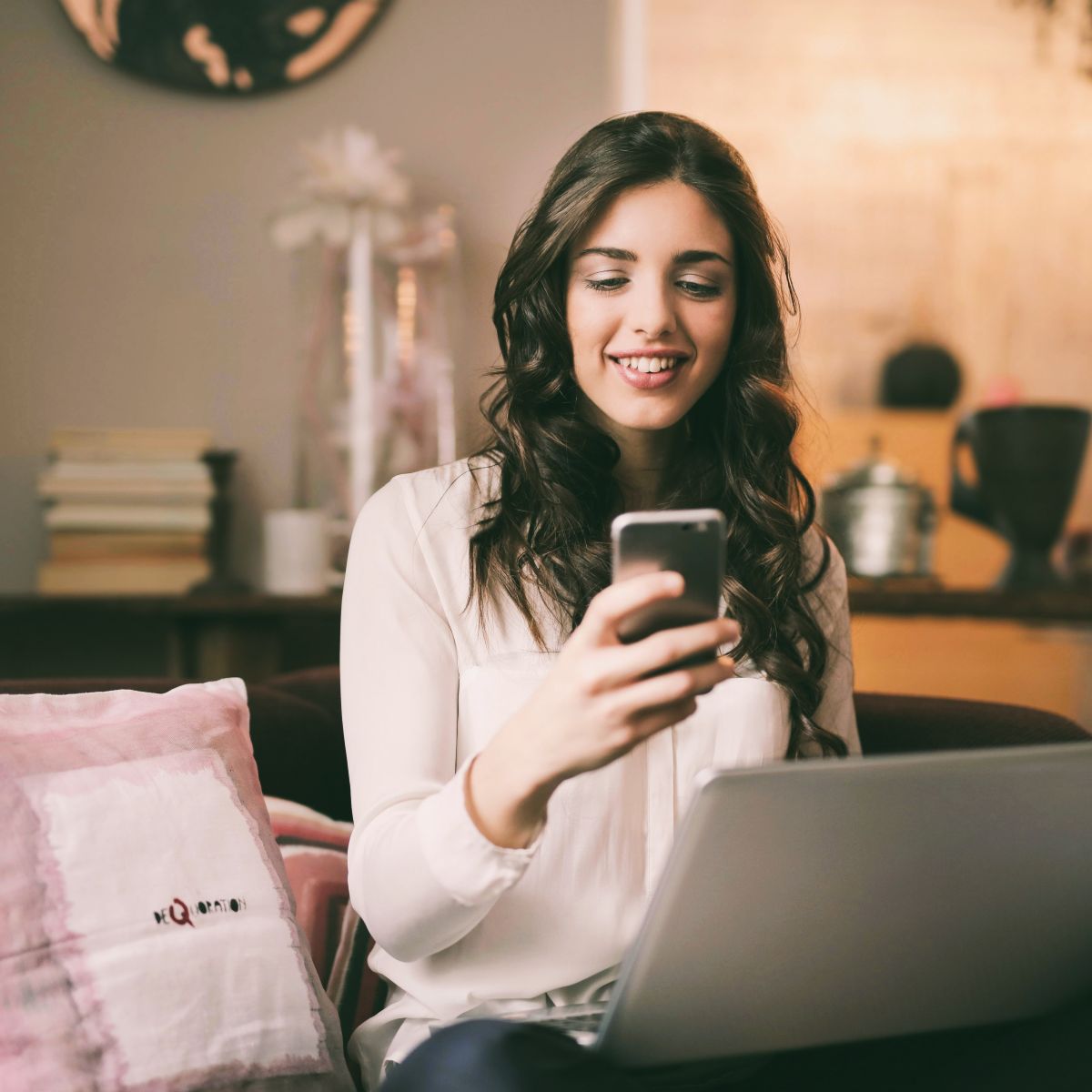 woman smiling looking at phone.